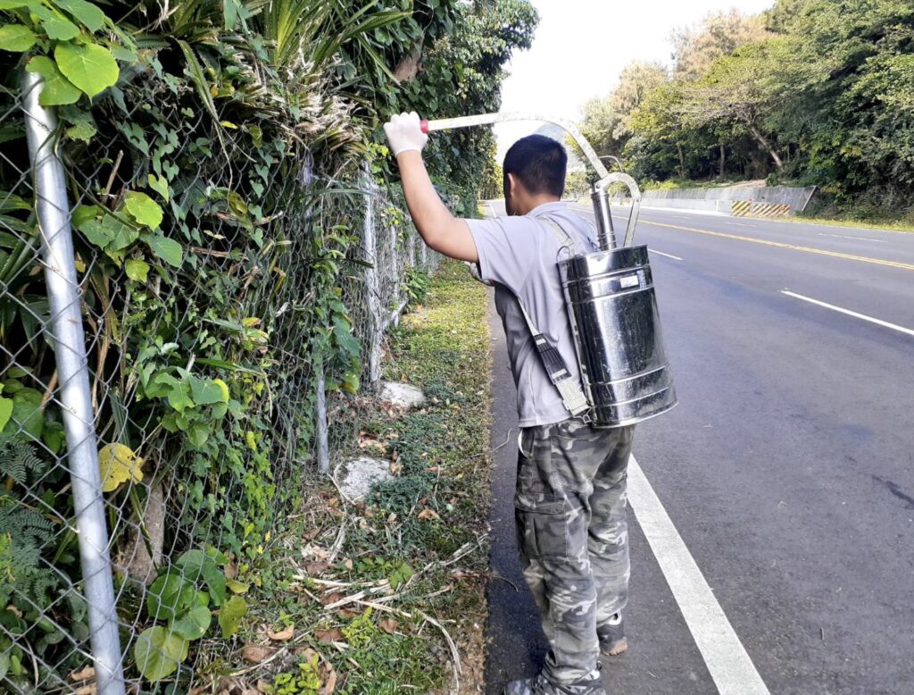 Performing liquid bait spraying.