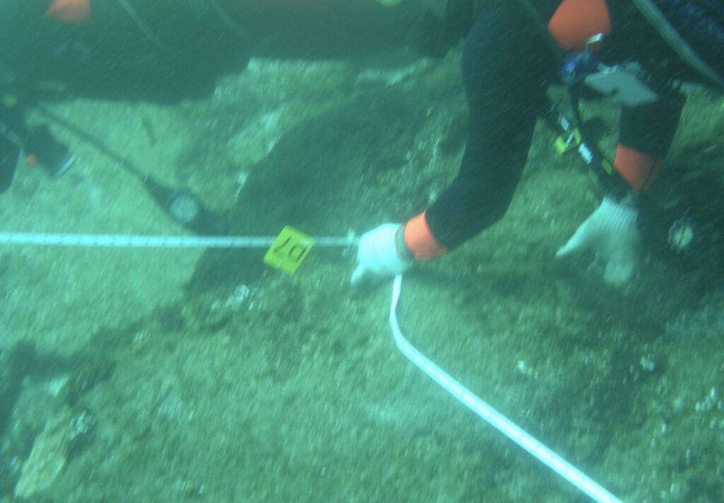 divers inspect wreckage of the ship