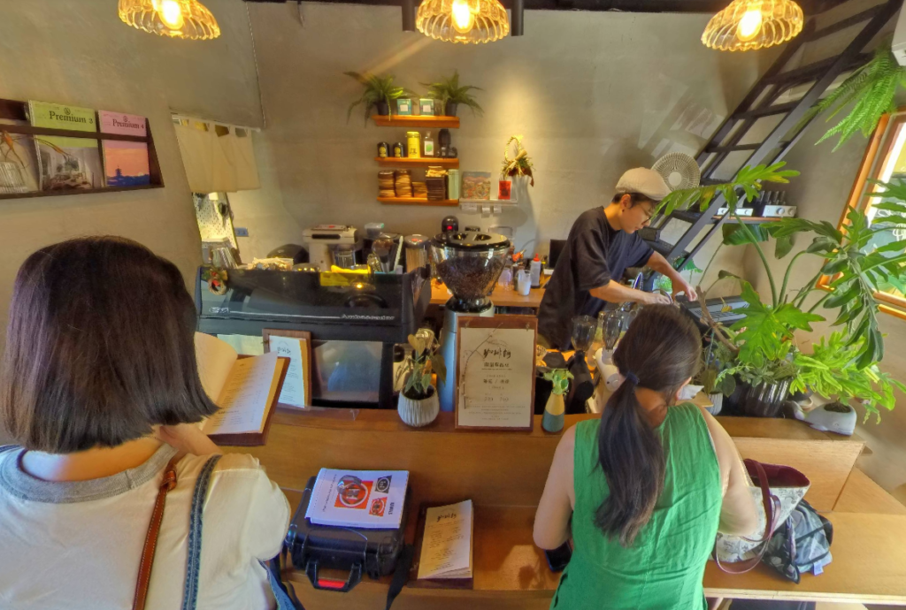 owner preparing coffee in cafe lounge